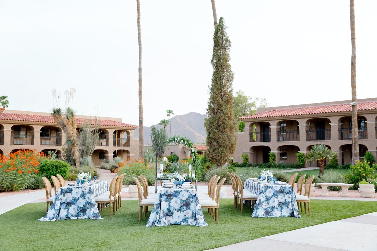 Outdoor reception tables with blue floral linens set up for an intimate event at The Scottsdale Plaza Resort